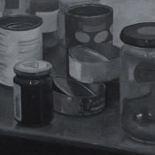 A still life of a tins and jars in black and white.